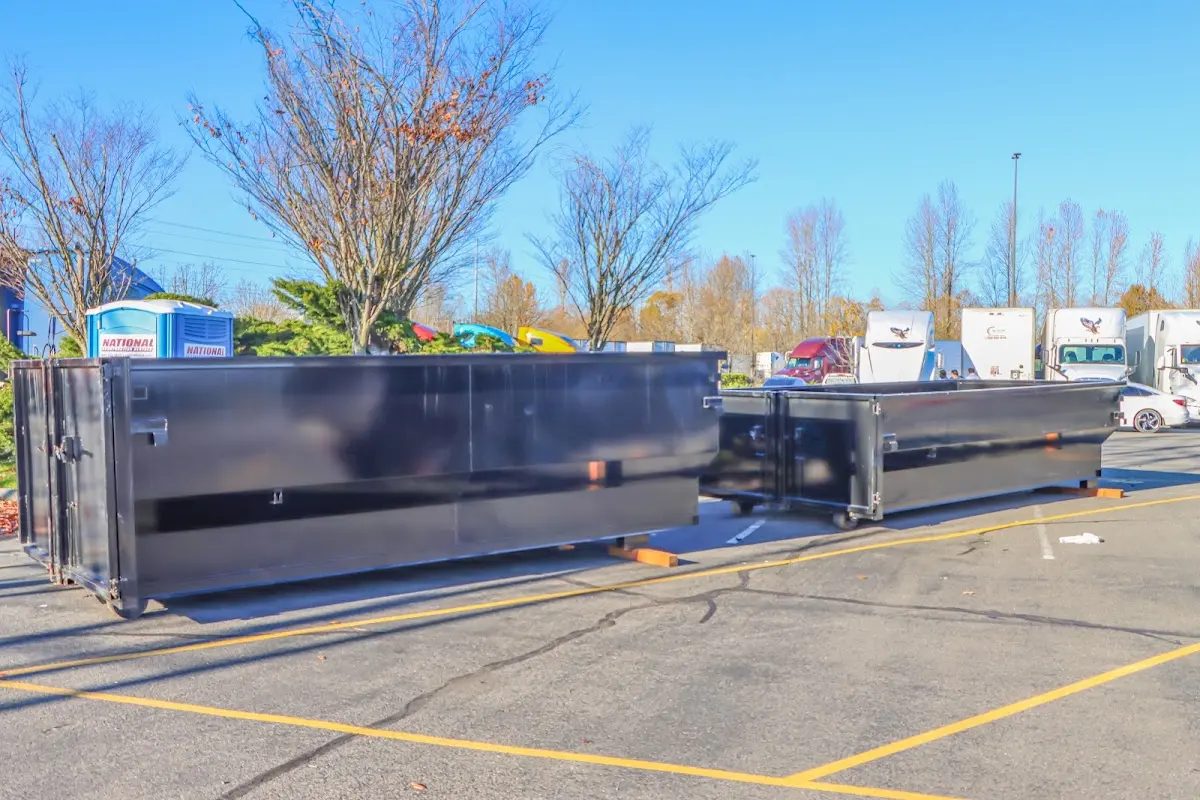 Professional dumpster rental service with roll-off container on residential driveway in Birch Bay